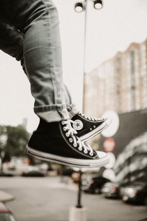 Free A Person Wearing Black Sneakers Stock Photo