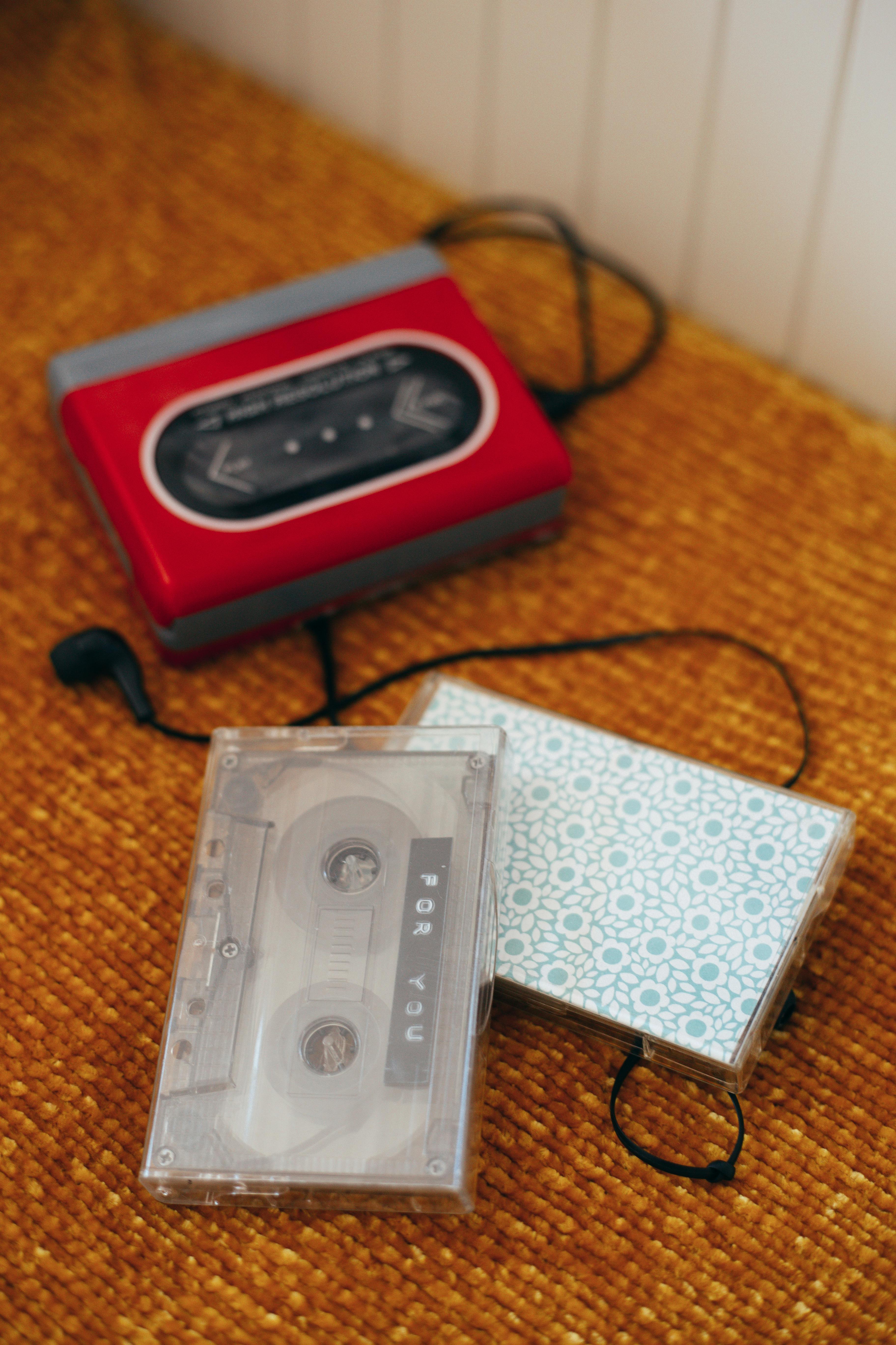 close up shot of cassette tape and cassette player