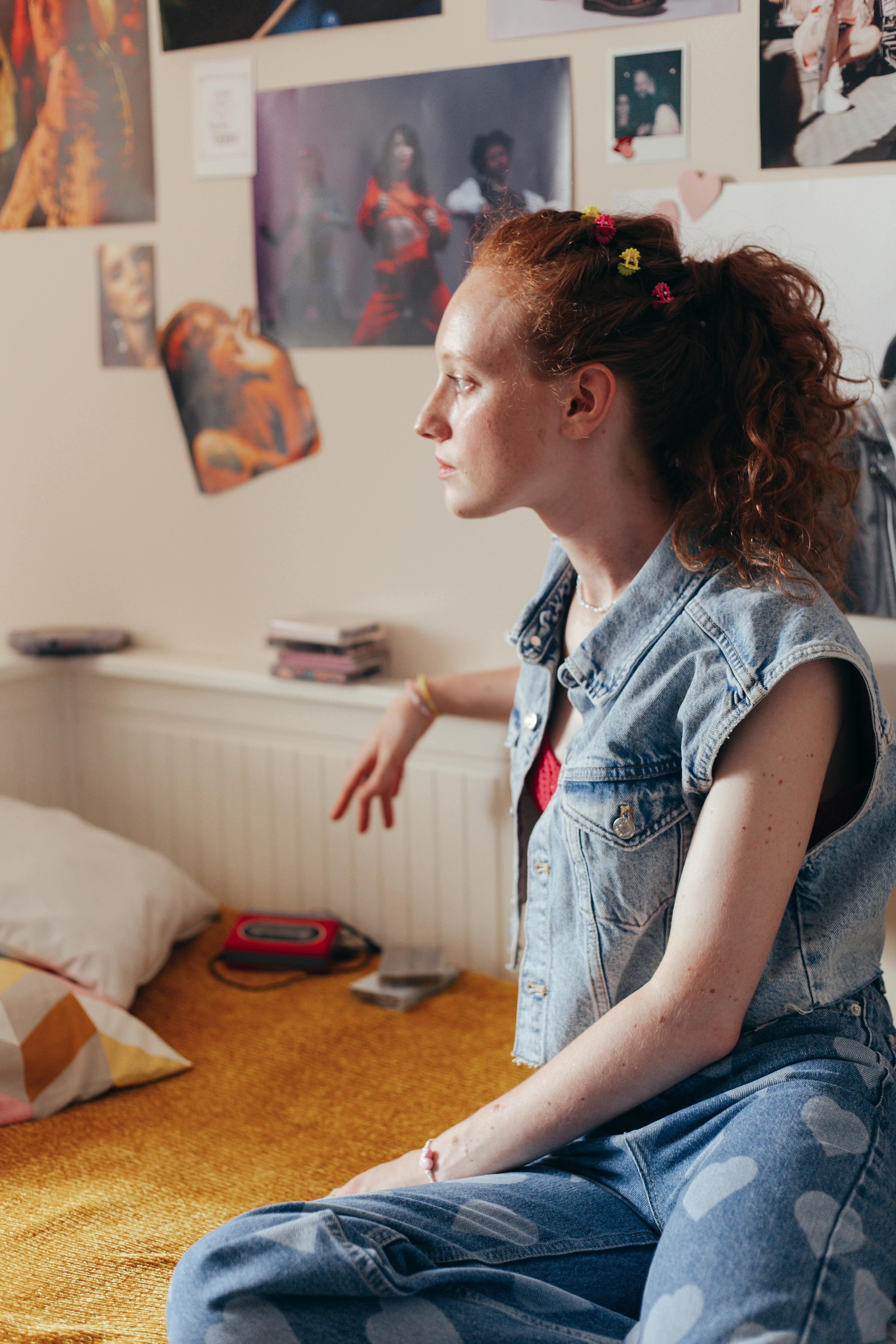 a woman wearing denim vest and denim pants