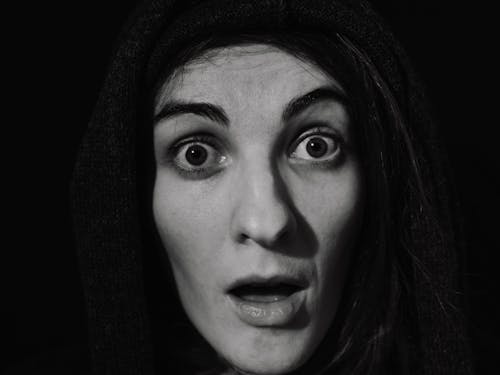 Free Grayscale Photo of a Person Looking Surprised Stock Photo