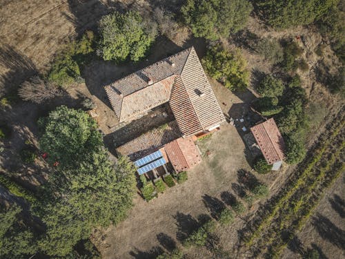 Aerial Photography of a Concrete House Surrounded by Green Trees