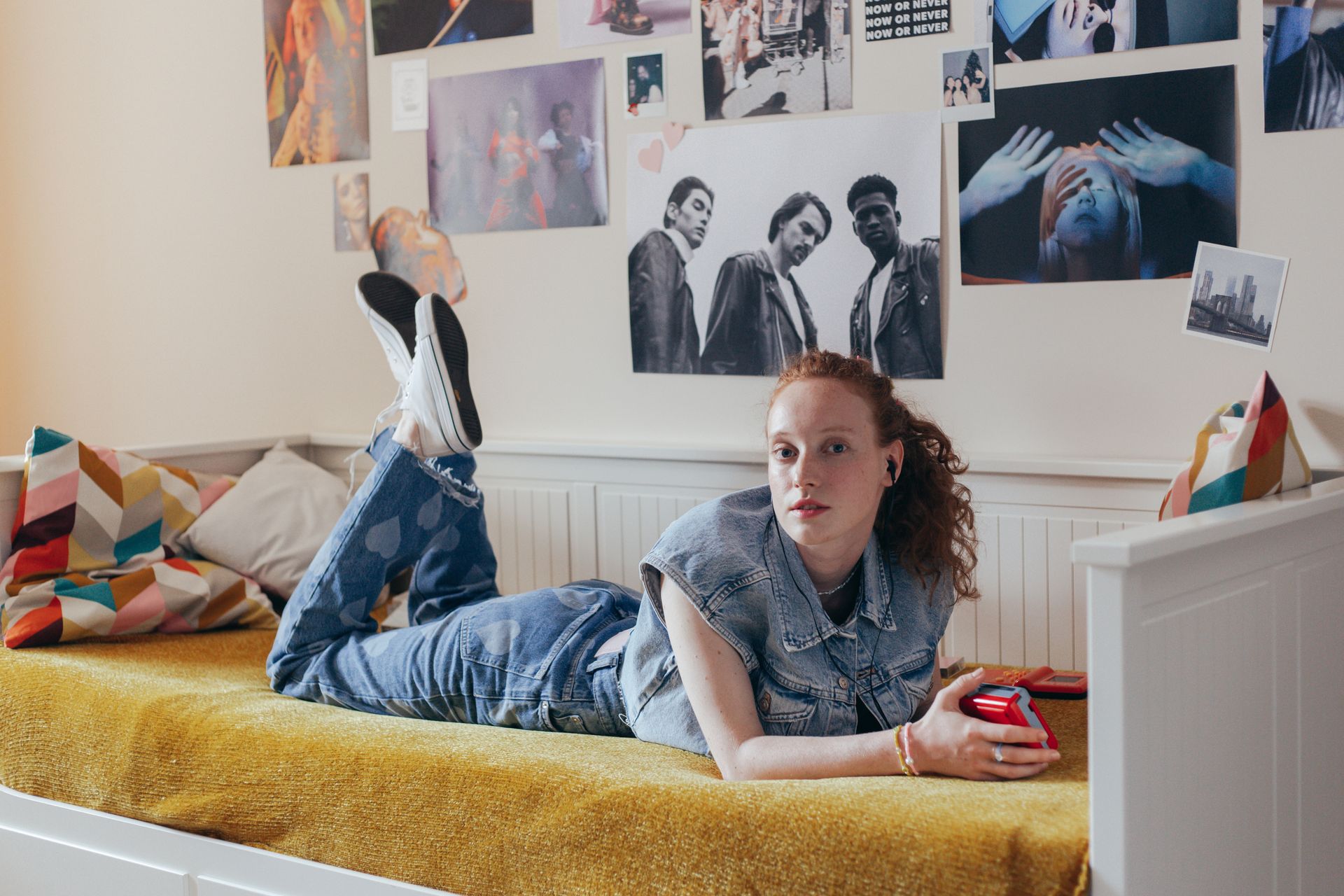 A Woman in a Denim Shirt Listening to Music while Lying Down