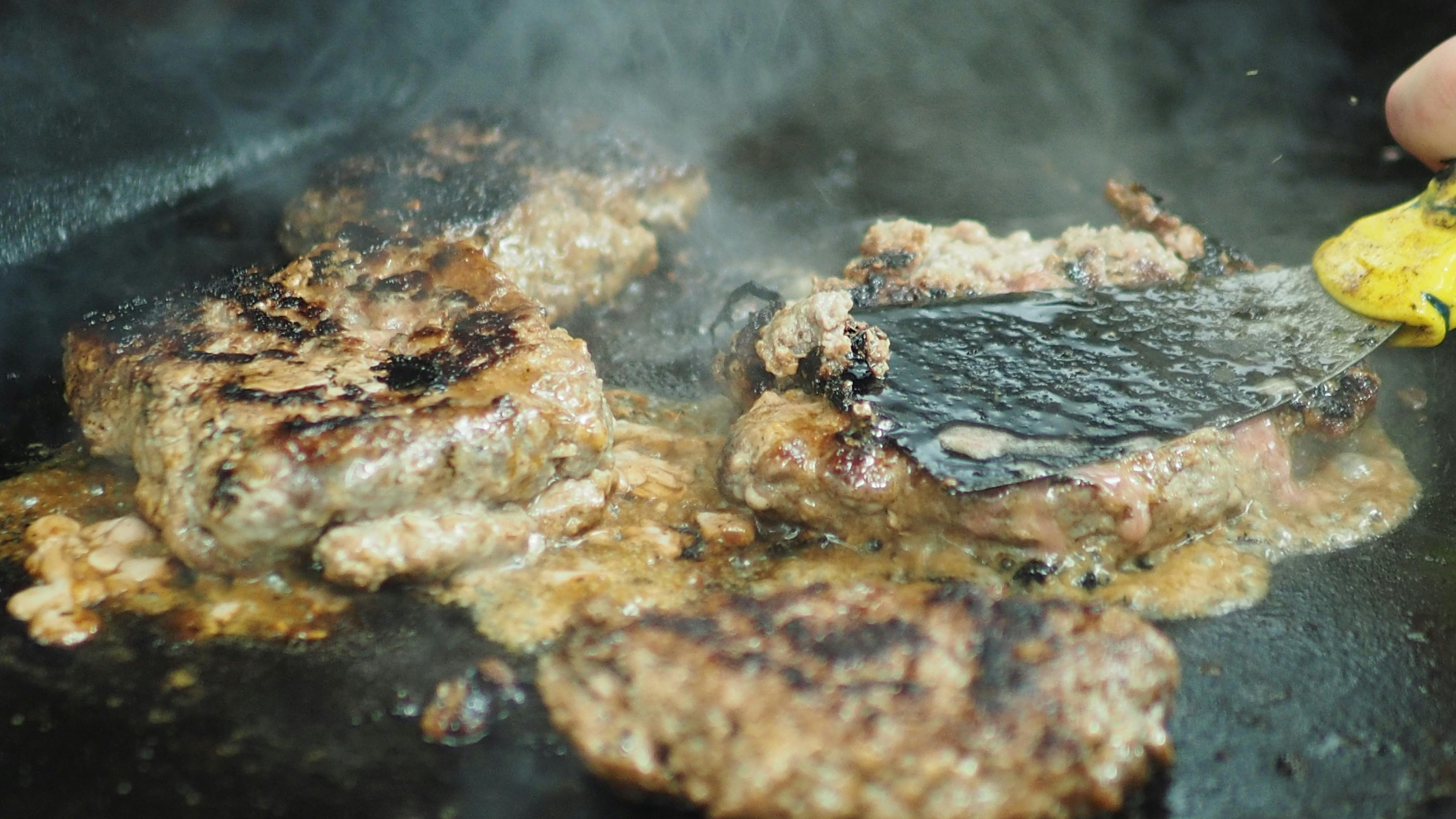 Free stock photo of burgers, fixing burgers, flipping burgers
