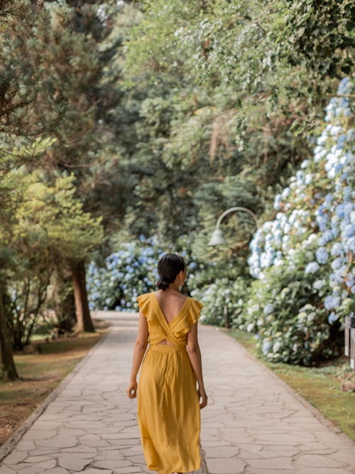 Free Woman in Yellow Dress Walking on Path Stock Photo