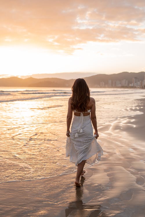 Woman Walking along the Seaside