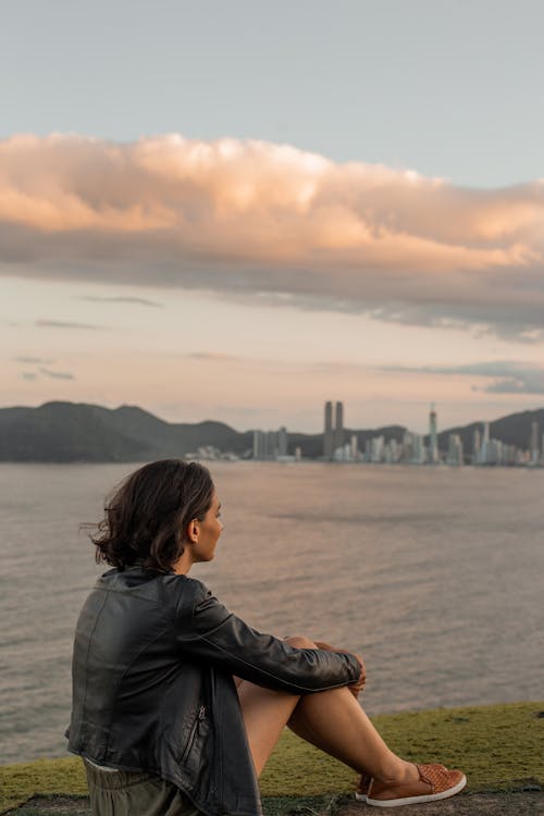 Free Woman in Black Leather Jacket Looking at the Sea Stock Photo