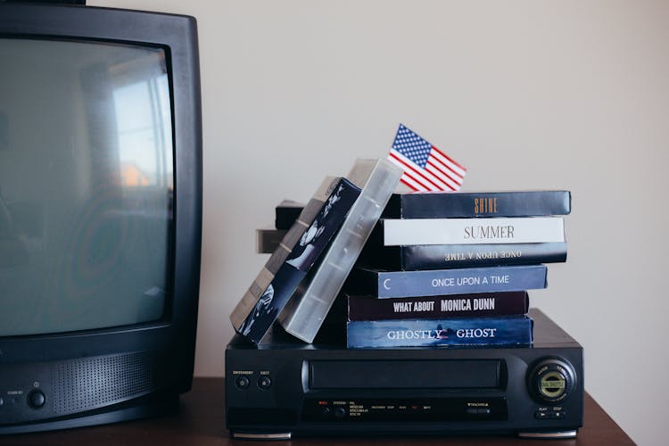 VHS Tapes On Top Of A VHS Player