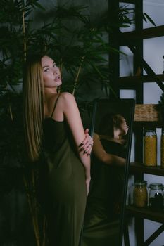Woman with Long Fair Hair Standing Before Mirror and Looking Over Shoulder