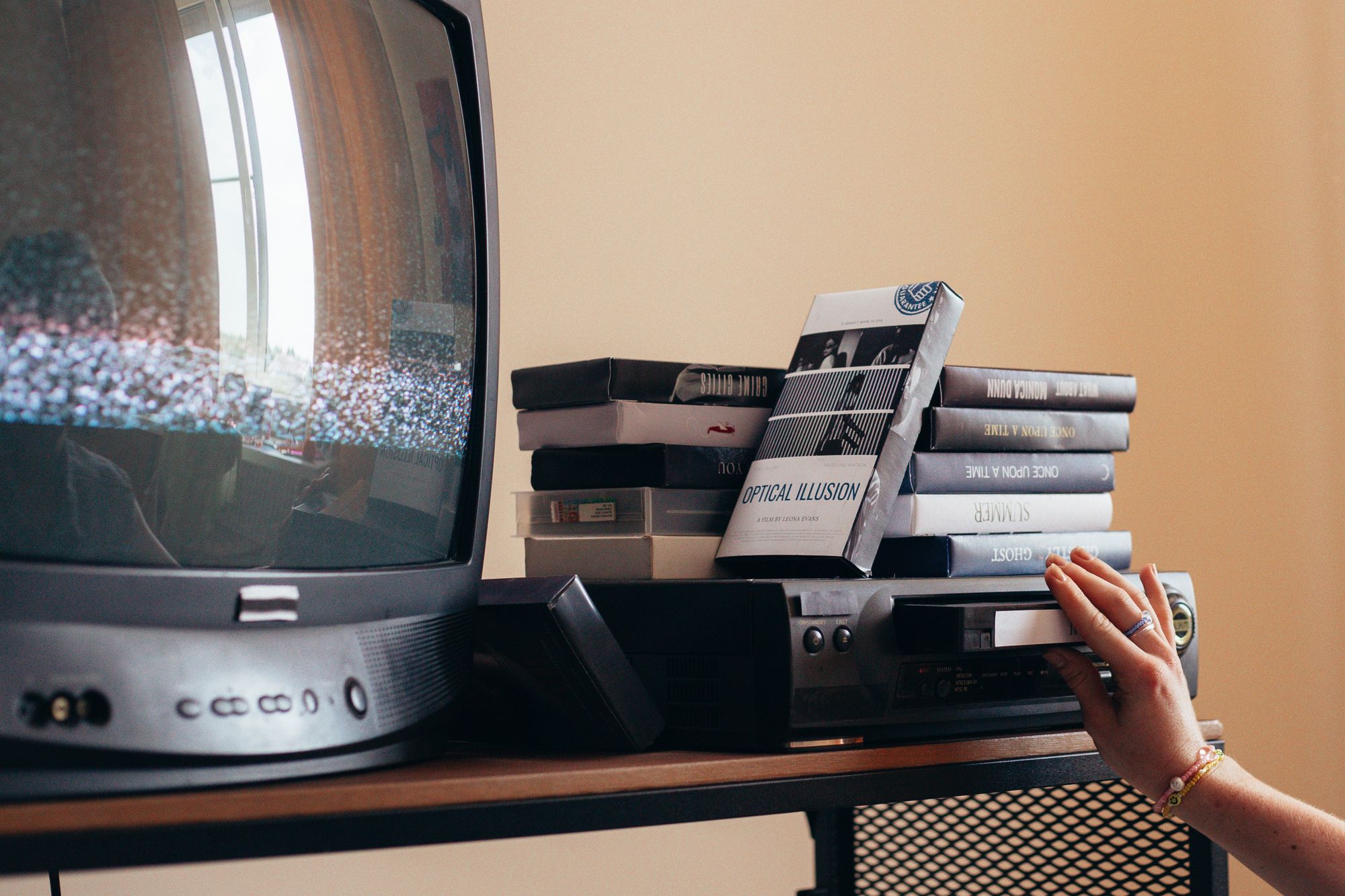 Vintage scene with a VHS player, tapes, and an old CRT TV creating a nostalgic vibe.