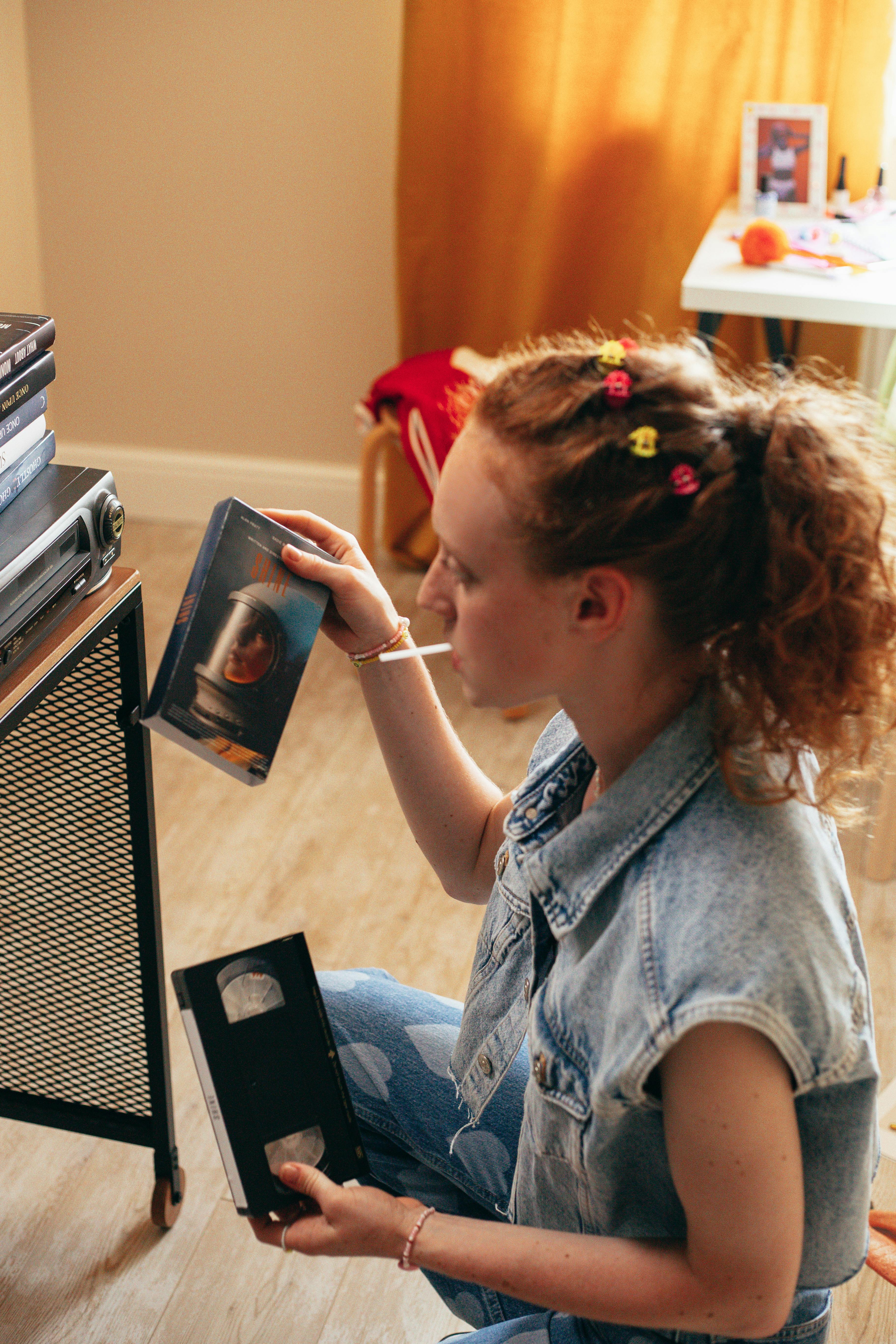 woman holding a vhs tape