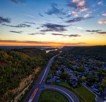 A stunning aerial view of Red Wing, Minnesota during sunset, showcasing natural beauty and urban landscape.