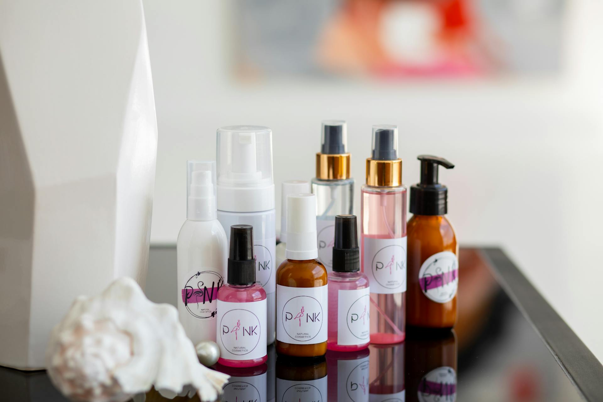 Collection of diverse skincare bottles arranged stylishly on a reflective surface, ideal for beauty concepts.