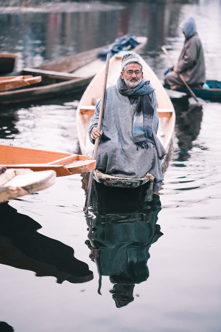 Lake And Men On Sailing On Canoes