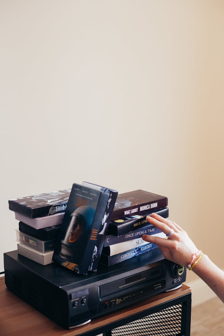 Stack Of Vhs Tapes On Vhs Player 