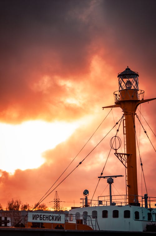 Free Dramatic sunset light cascading over the Irbensky lighthouse in Kaliningrad, Russia, with vibrant clouds. Stock Photo