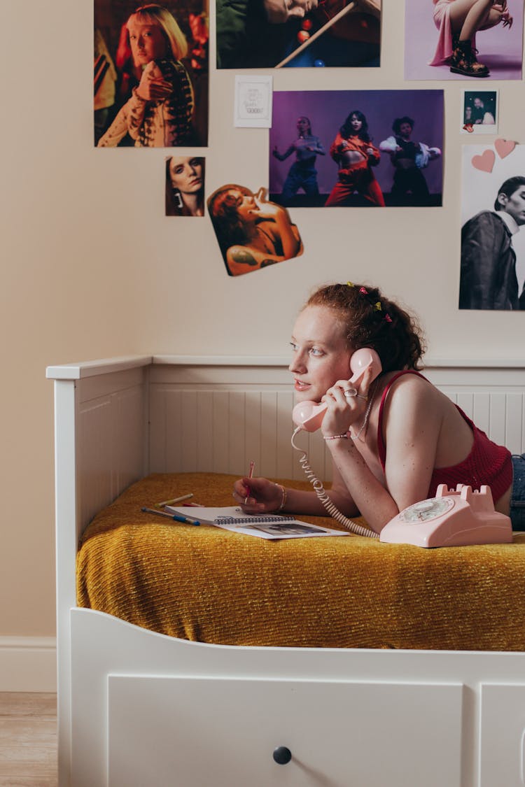 Woman Lying On Couch While On A Telephone Call