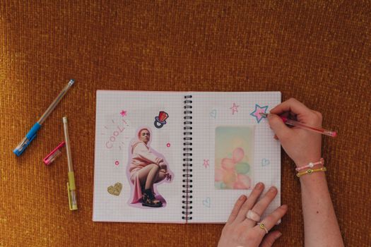 Colorful flat lay of a craft journal with creative doodles and stickers.