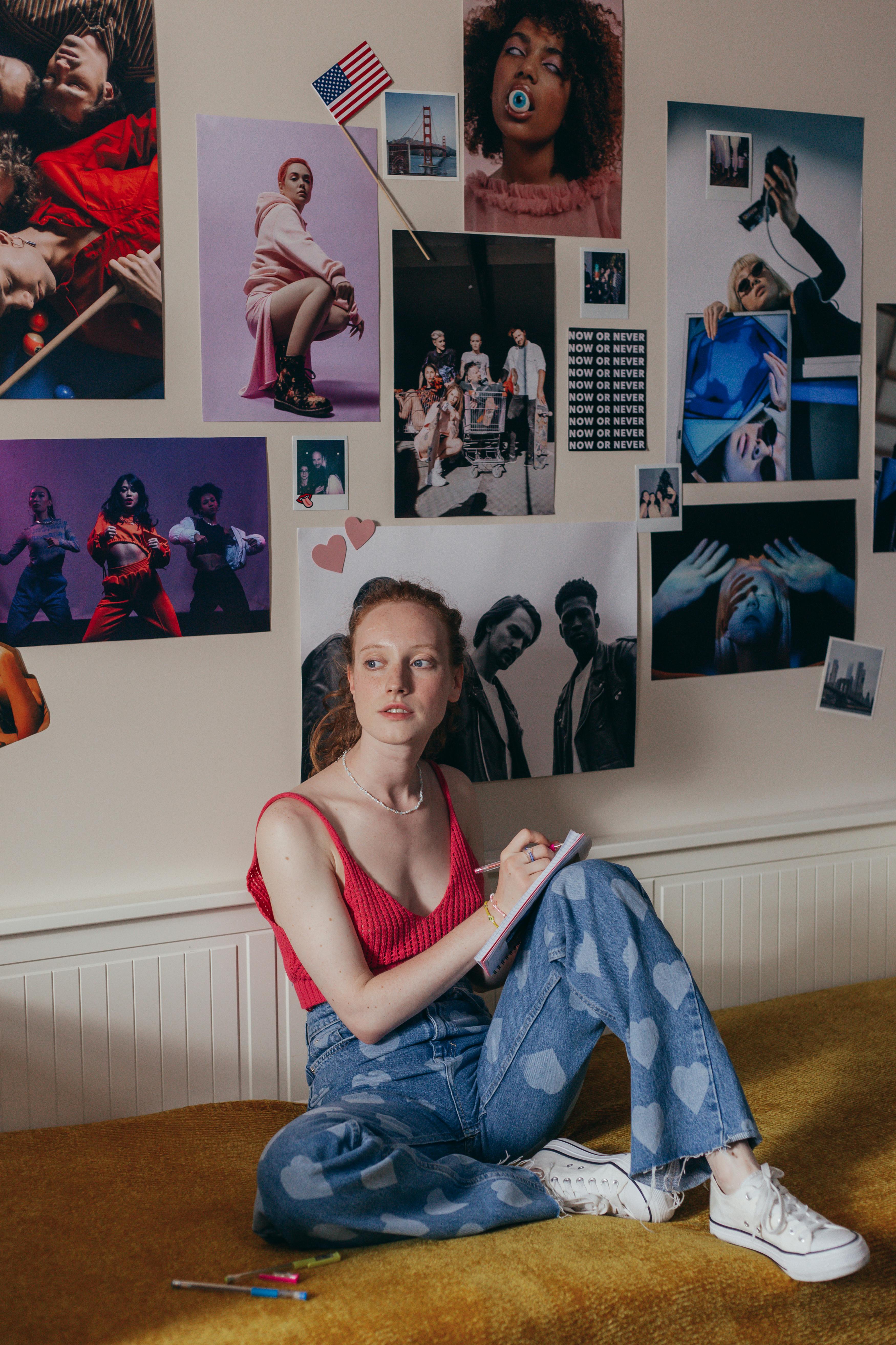 a woman in red tank top sitting on the floor