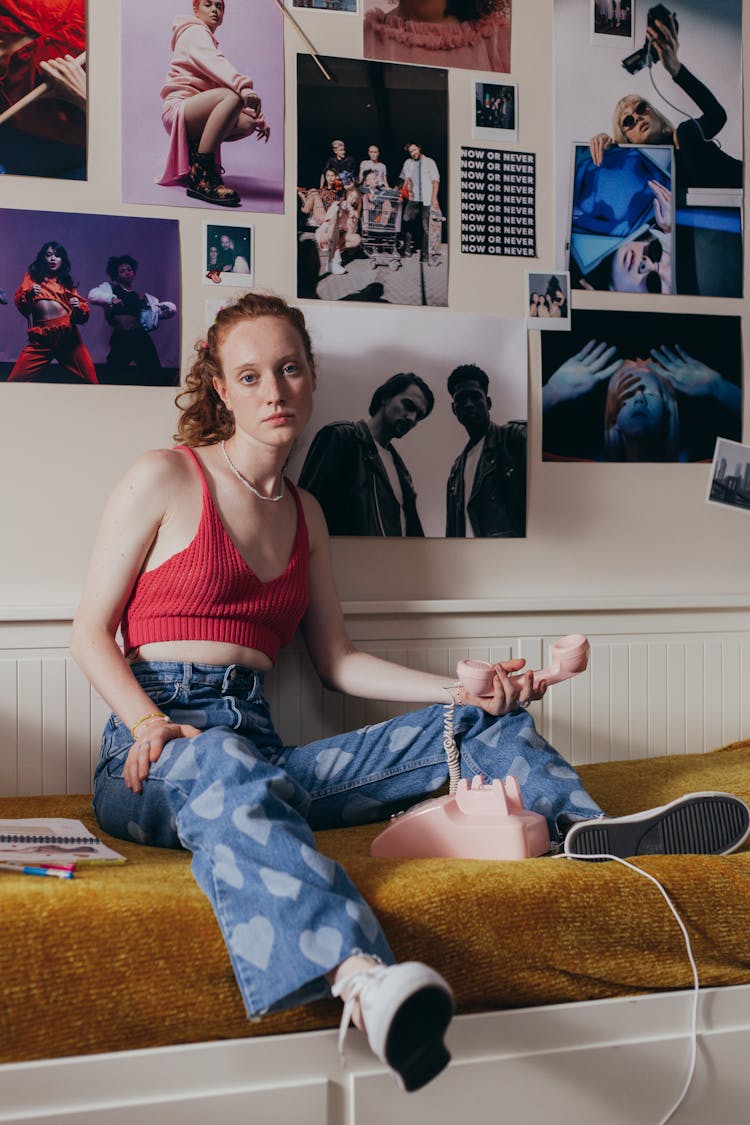 Woman Sitting On The Bed Holding A Telephone Handset