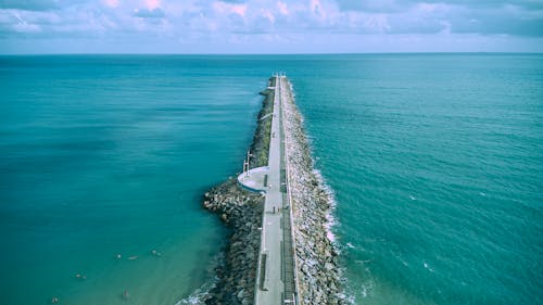 Gray Concrete Road Beside Body of Water