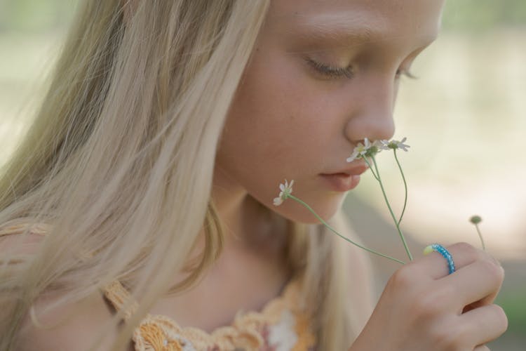 Girl Smelling Flower