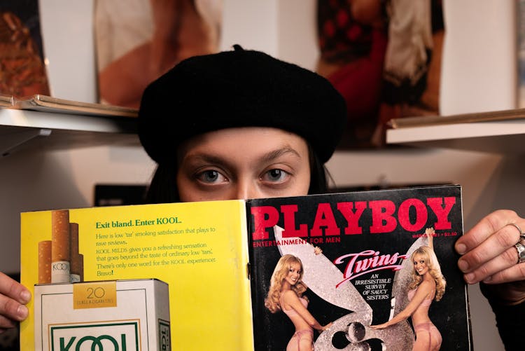 Woman Holding Playboy Magazine Cover