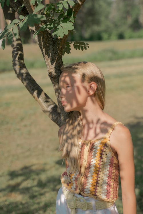 Girl Standing next to Tree