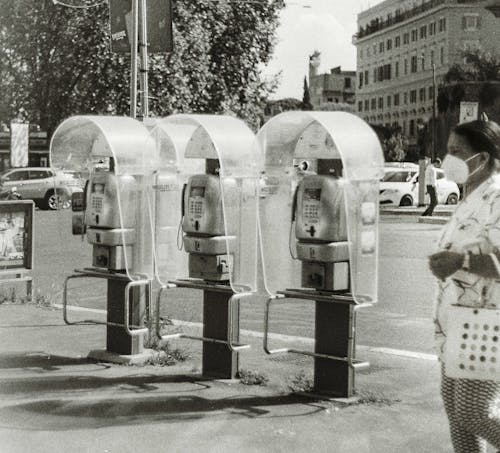 Grayscale Photograph of Public Telephones on the Street