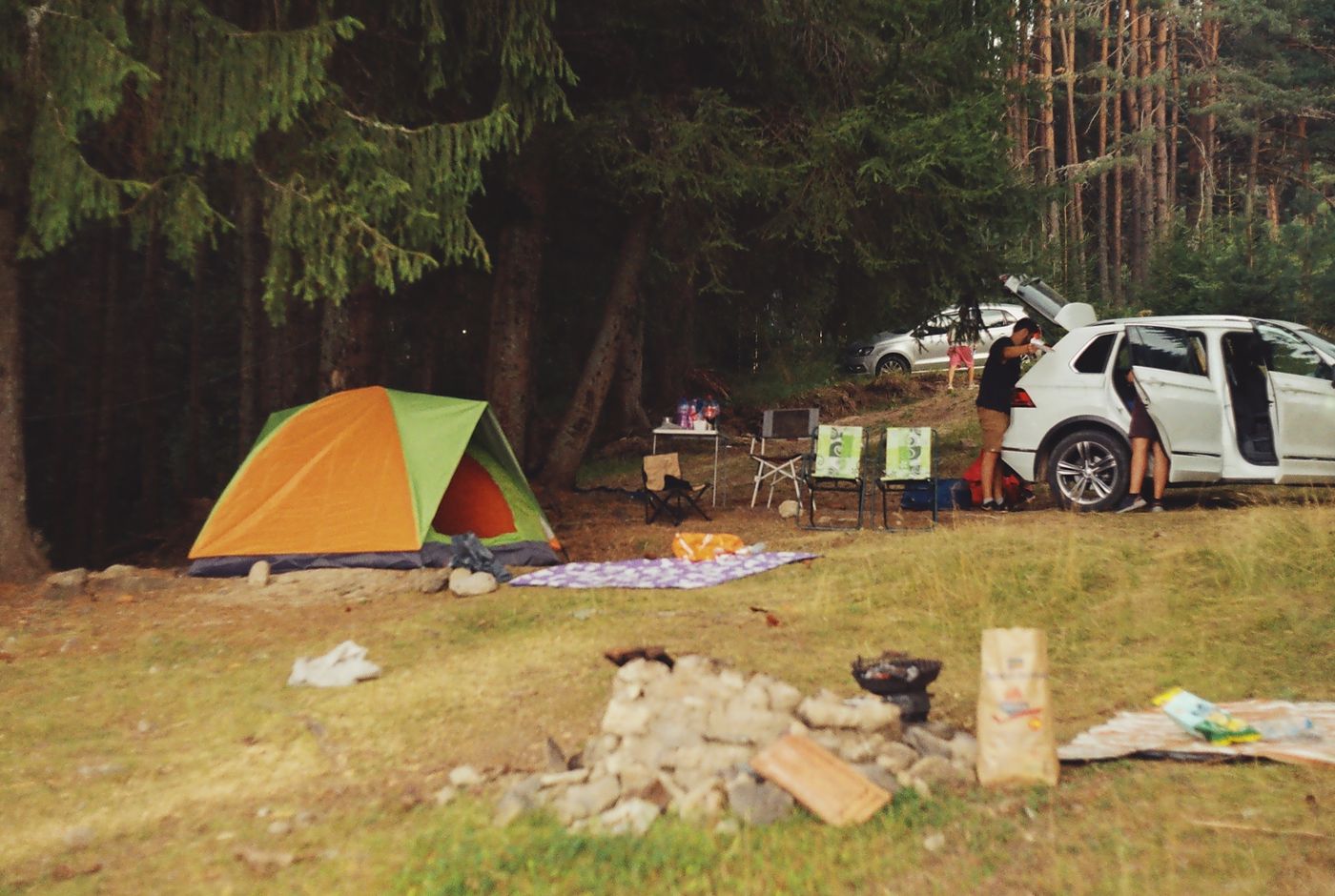 Camping equipment arranged at a woodland campsite