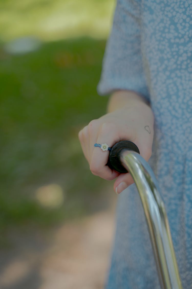 Close-up View Of Girl Holding Bike Handlebar