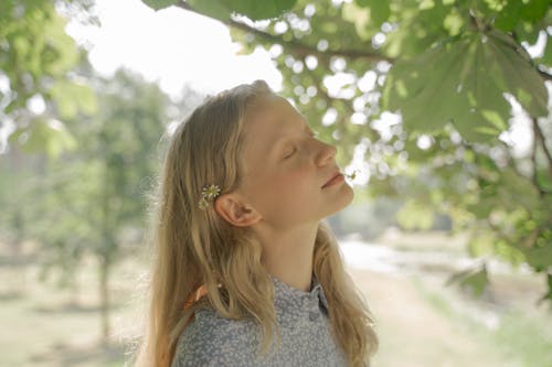 Blond Haired Teenage Girl with Eyes Closed