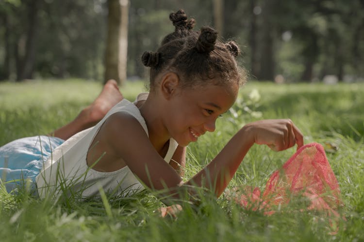 Girl Lying In Grass In Park