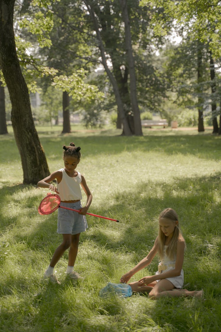 Girls Playing With Colorful Nets In Grass