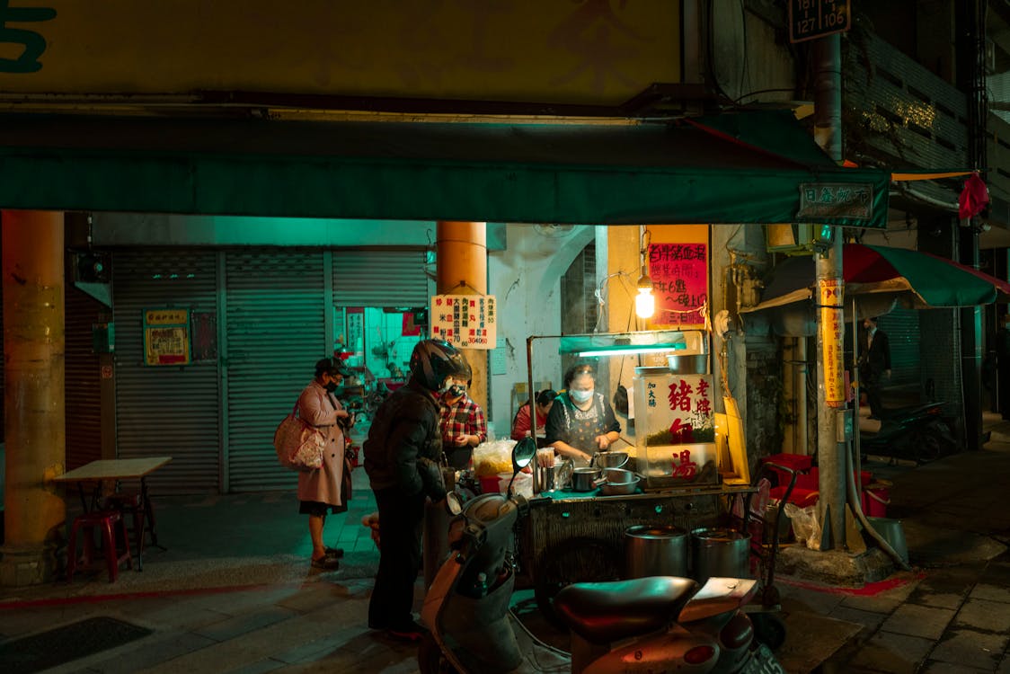 Parked Scooter in front of a Food Cart