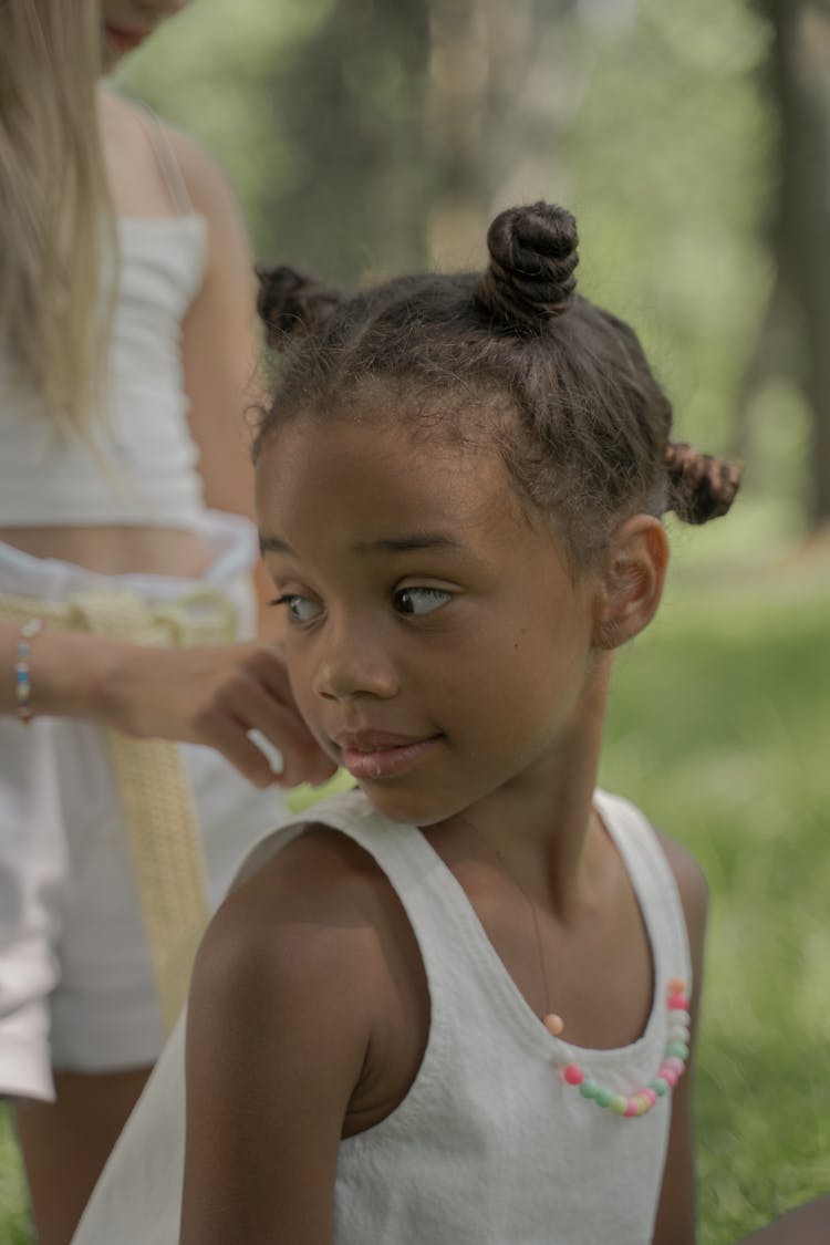 Blond Unrecognizable Girl Doing Hair Style Of Teenage Afro-American Girl