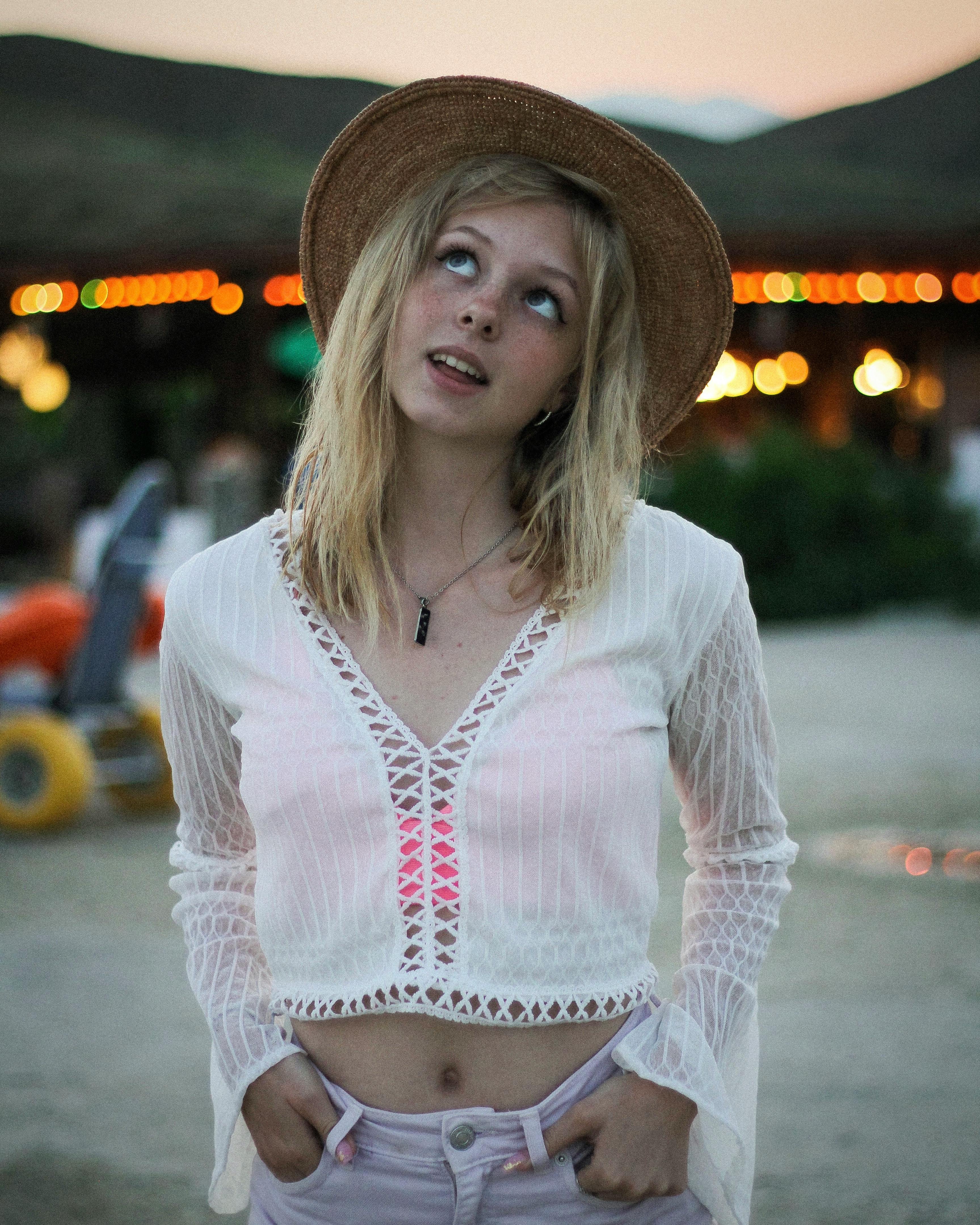 Photo of a Woman with a Brown Hat Looking Up while Her Hands are in Her  Pockets · Free Stock Photo