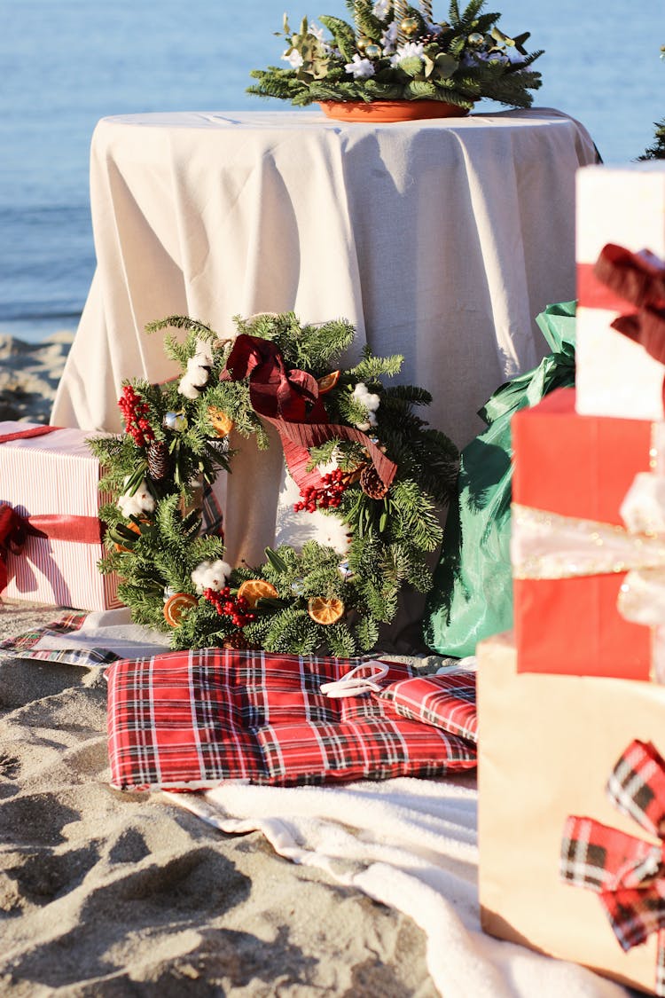 Christmas Wreaths And Presents On The Beach 