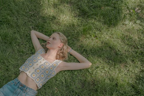 Free Blond Young Woman Laying on Lawn on Summer Sunny Day Stock Photo