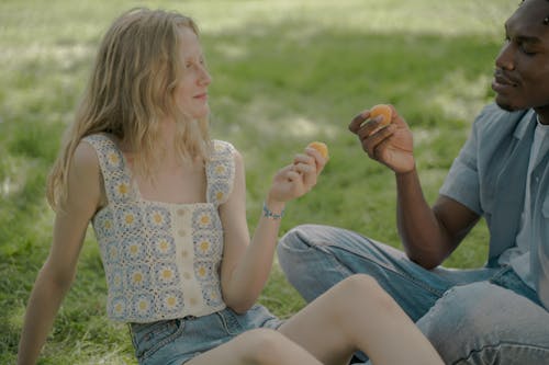 Young Couple Having Date in Park and Enjoying Apricots