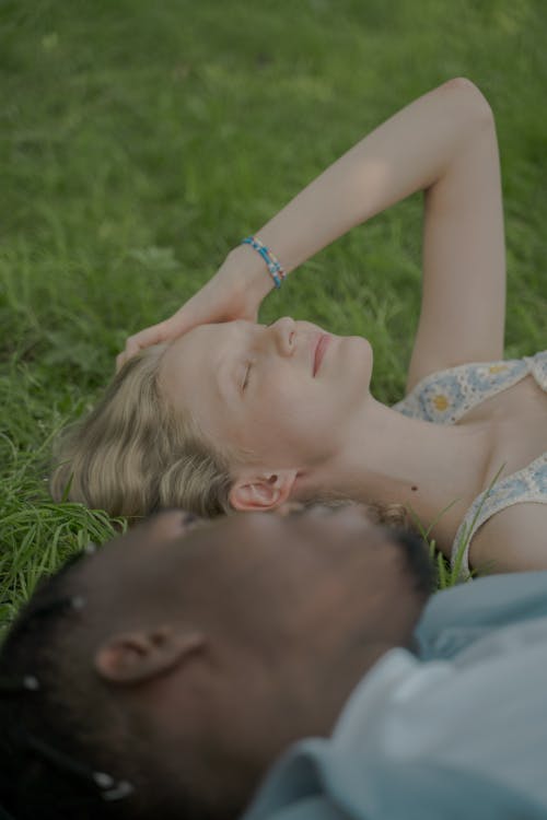 Man and Woman Laying on the Grass