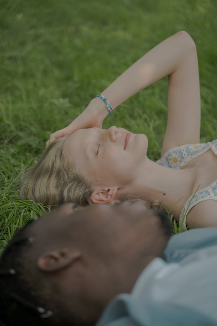 Man And Woman Laying On The Grass