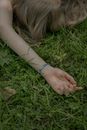 Hand of a Woman Laying on the Grass