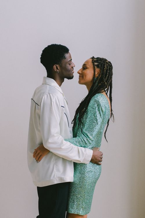 Free A loving couple embraces in a simple and elegant setting, symbolizing romance and connection. Stock Photo
