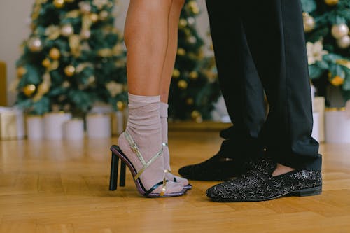 Free Woman Wearing High Heels with Socks Standing Close to a Man in Black Trousers and Shoes Stock Photo
