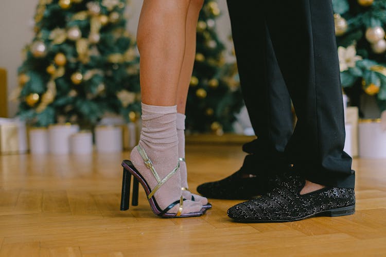 Woman Wearing High Heels With Socks Standing Close To A Man In Black Trousers And Shoes