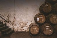 Brown Wooden Barrels Beside White Painted Wall