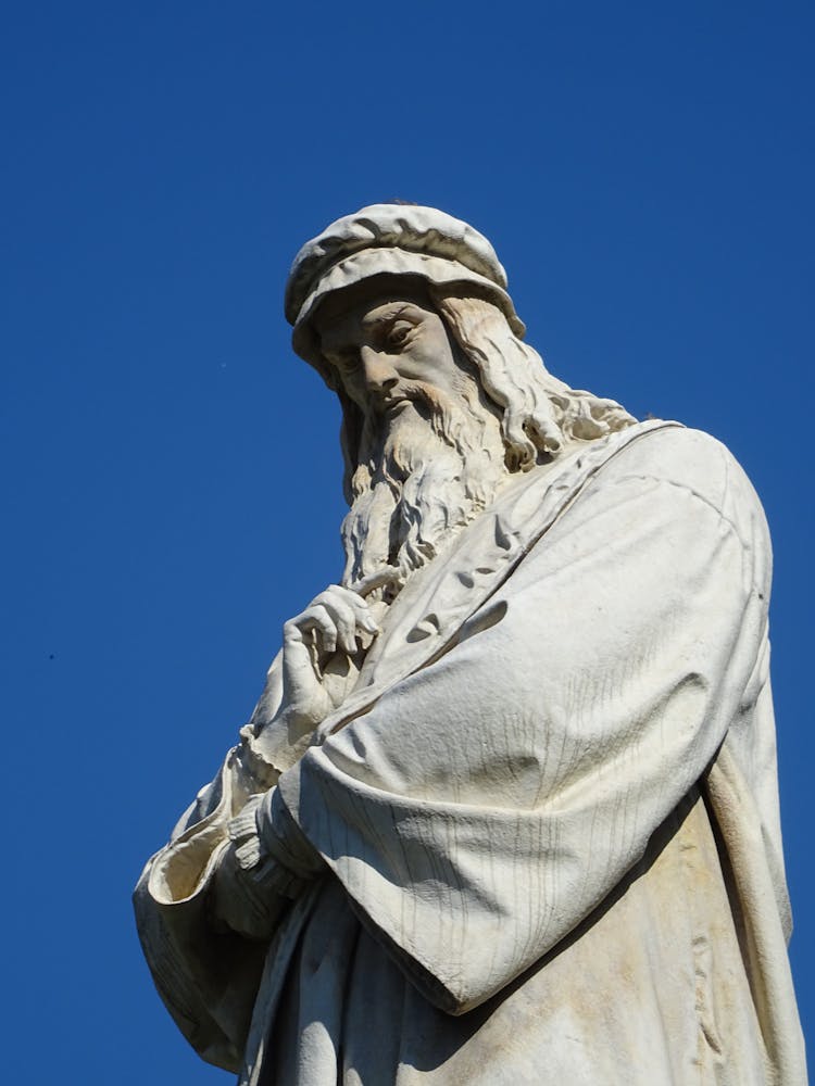 The Statue Of Leonardo Da Vinci On Clear Blue Sky In Italy