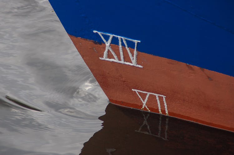 Closeup Of Blue And Red Boat With Roman Numerals