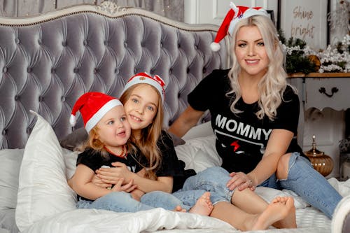 Free Woman and Girls Wearing Santa Hats Stock Photo