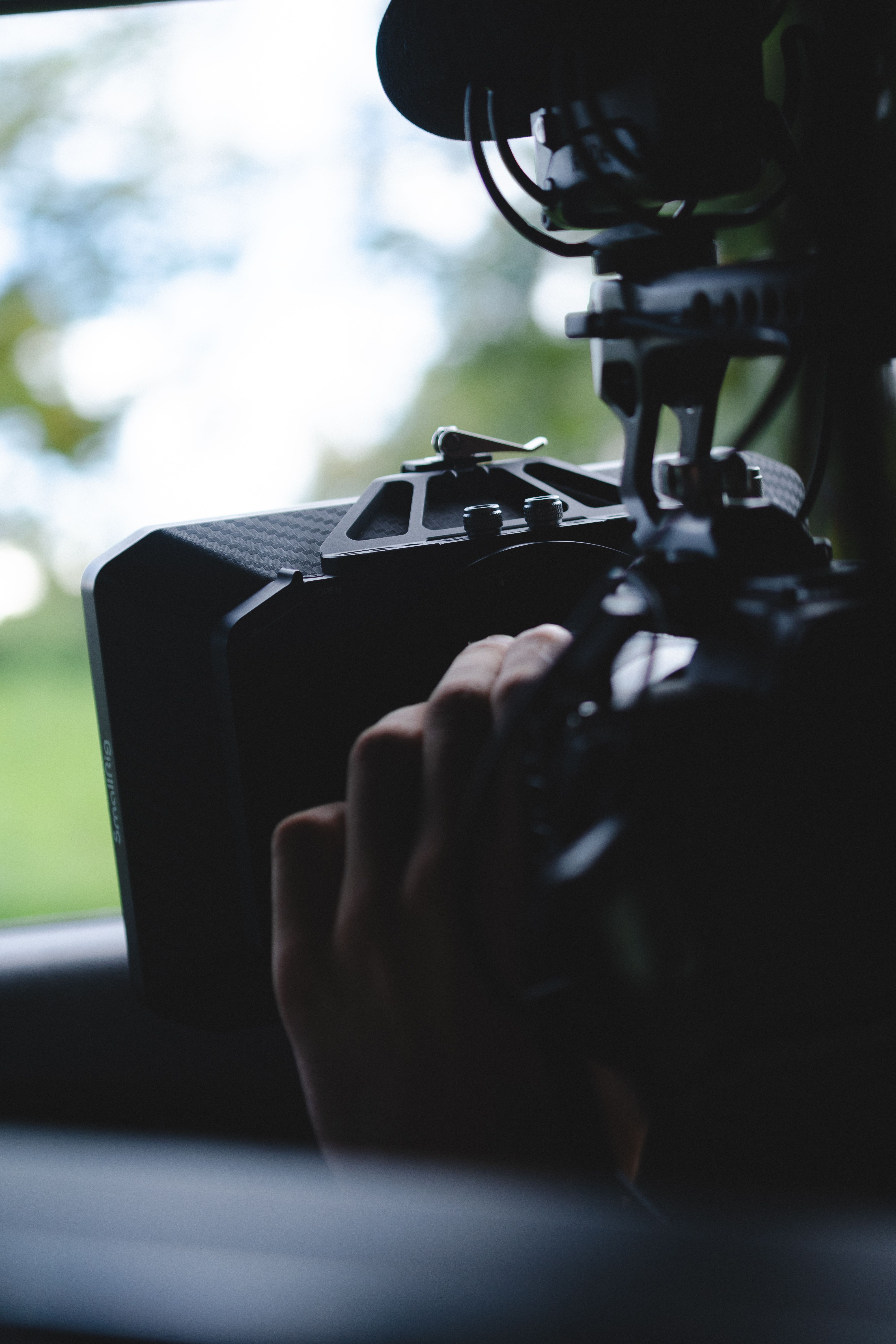 Close-up of a professional camera setup outdoors, highlighting videography equipment.